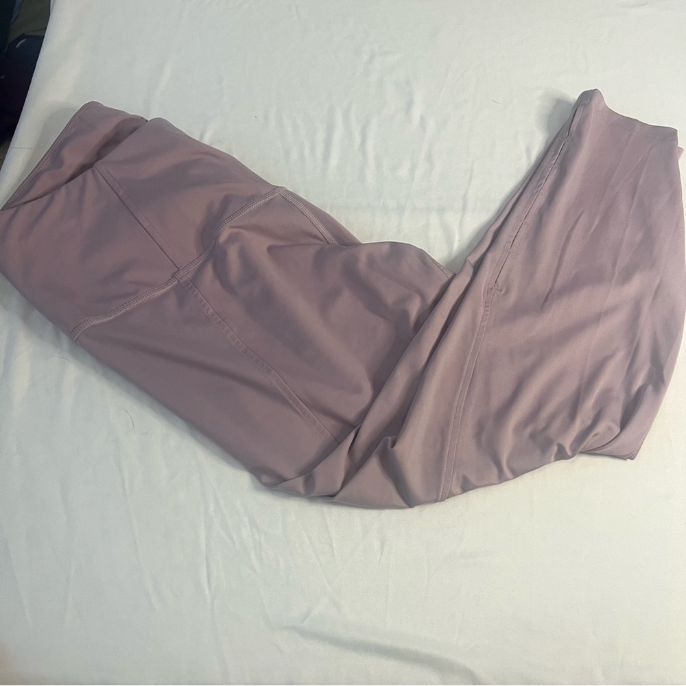 Nike Women's Mauve Yoga  Leggings with cut out detail on lower leg